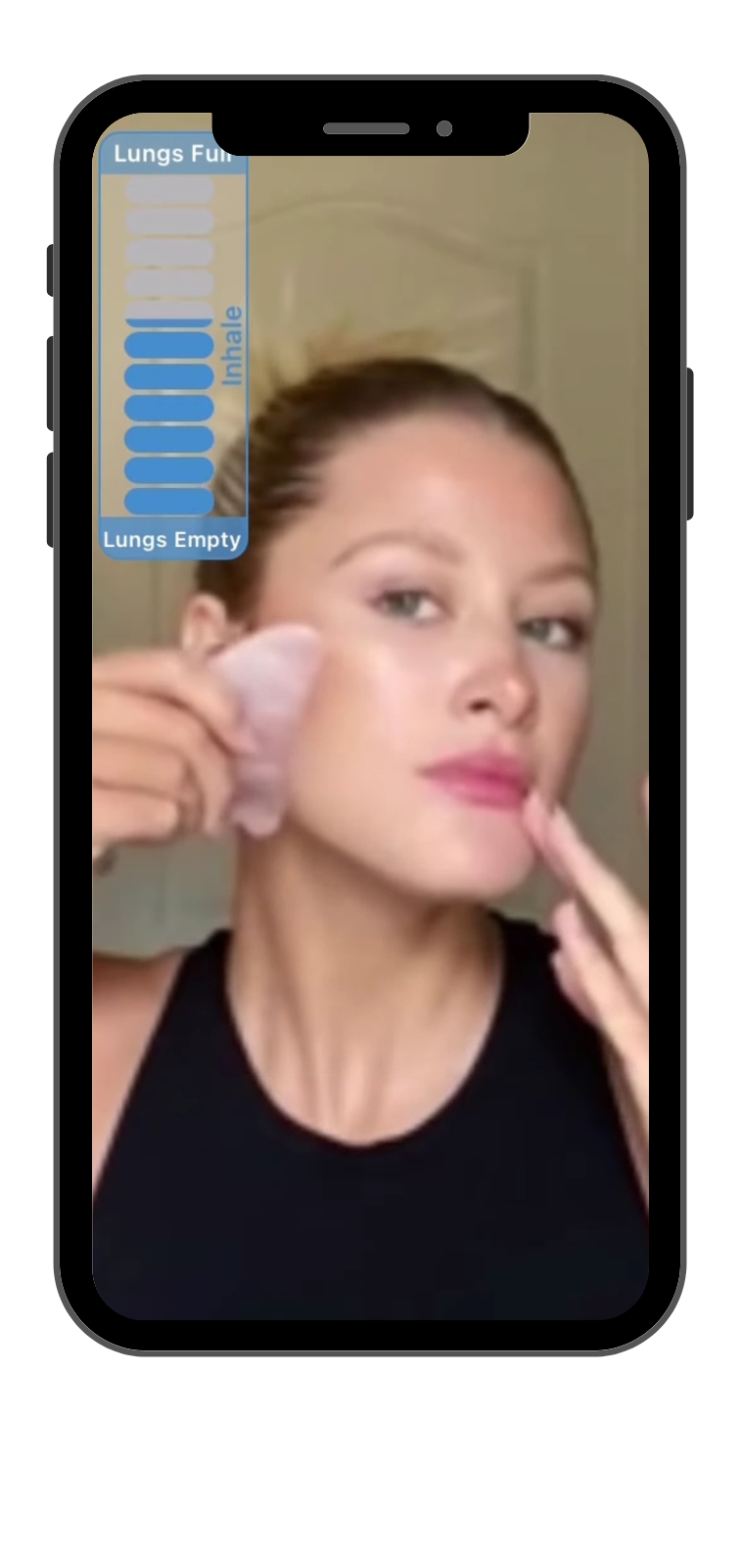 A skilled practitioner showcasing the Gua Sha technique on the cheeks.
