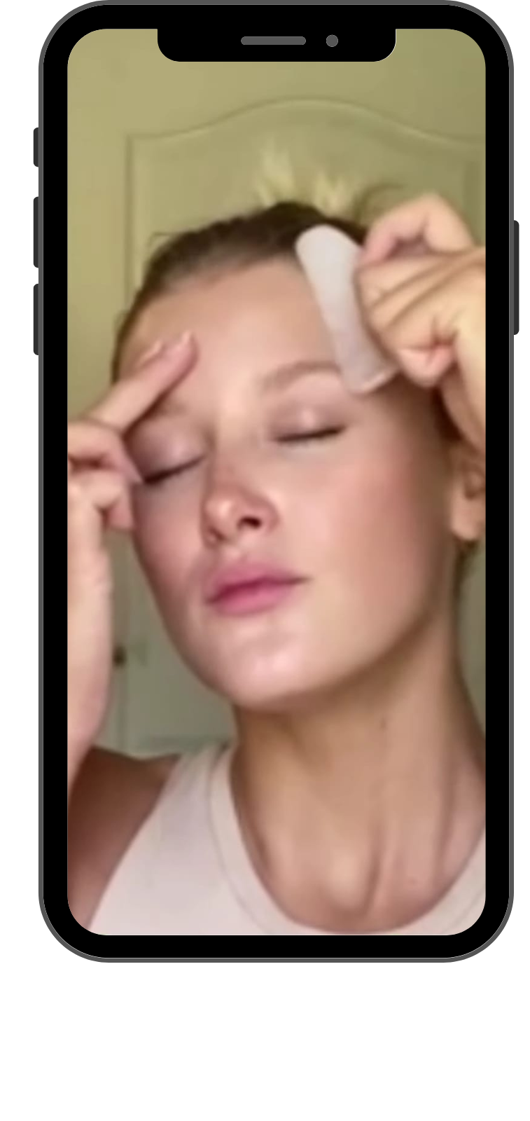 Expert performing the Gua Sha technique with Dolphine-shaped rose quartz tool.