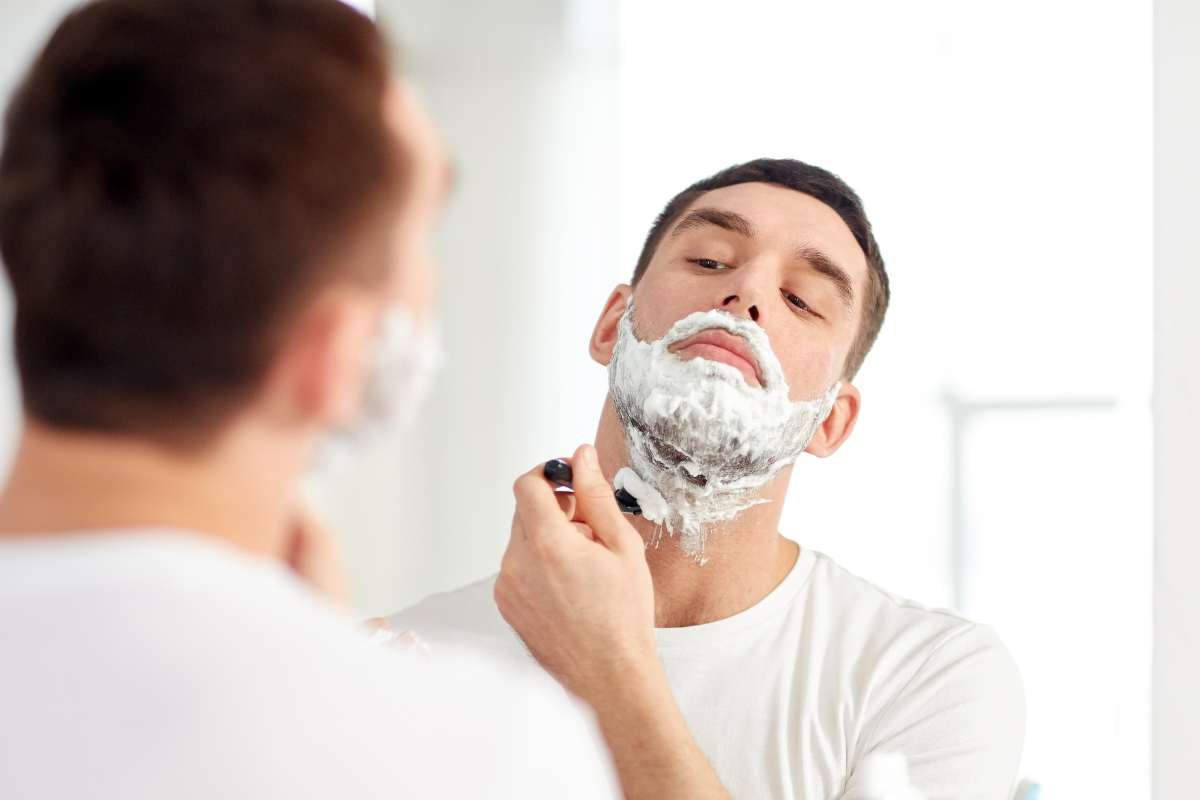 Man shaving beard ( men grooming)
